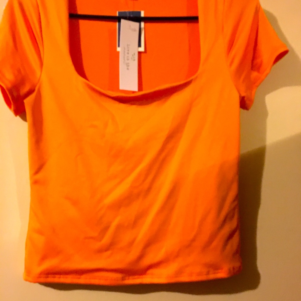 A cute top that’s a skins knockoff. , Pretty peachy orange color !